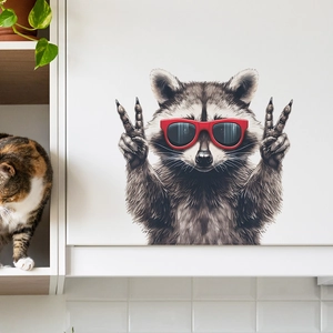 Funny raccoon wall sticker with red sunglasses and peace sign on white cabinet