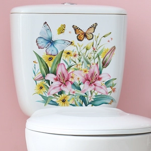 Detail showing colorful flower and butterfly decals on a white ceramic toilet tank surface