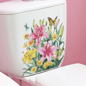 Detail of pink lily flowers and butterflies wall decal applied on a white toilet tank surface