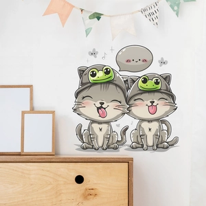 Detail of cartoon cats with frog hats wall stickers in a cozy child bedroom setting