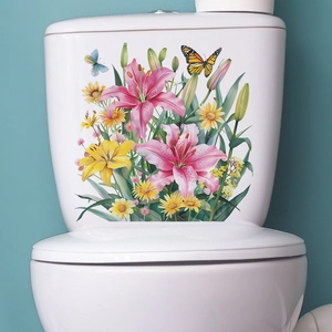Detail of floral toilet stickers featuring pink lilies and butterflies on a white tank