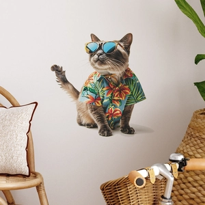 Siamese cat wearing blue summer floral shirt and stylish round sunglasses in home setting