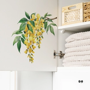 Self-adhesive wall sticker featuring hanging yellow flowers and green leaves on white cabinet