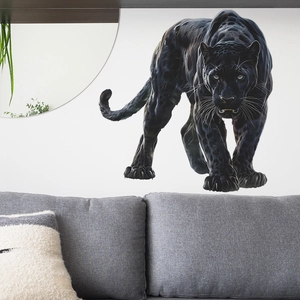 Realistic black panther wall sticker decal displayed above a modern grey sofa on white wall