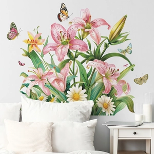 Bedroom wall featuring pink lily and daisy floral stickers with colorful butterfly accents