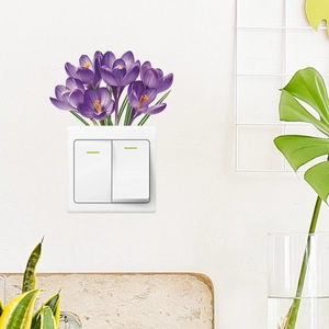 Macro detail of purple crocus wall stickers applied on a white wall around a light switch