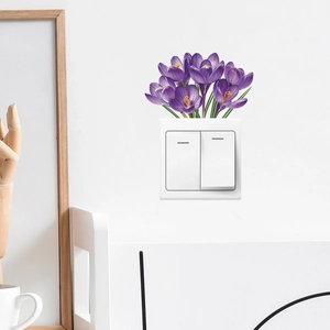 Detail of purple crocus flower wall sticker on white wall with wooden home decor