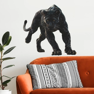 Detailed realistic black panther wall sticker displayed above an orange velvet sofa
