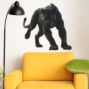 Detailed view of a 3D black panther wall decal above a yellow sofa in a modern living room