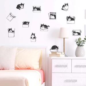 Detailed view of cartoon cat wall decals applied in a warm bedroom setting
