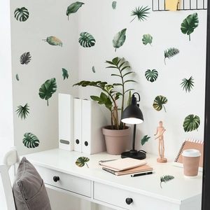 Macro detail of waterproof PVC monstera and palm leaf wall stickers in a home study room