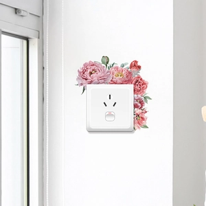 Detail of pink floral peony wall decals surrounding a modern white light switch panel