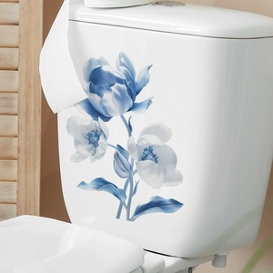 Close-up of elegant blue tulip floral stickers applied on a white ceramic toilet tank