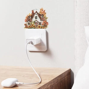 Close-up of watercolor cottage and sunflower wall sticker applied near a power socket