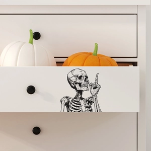 Black skeleton vinyl wall decal for Halloween home decor on white drawer cabinet surface