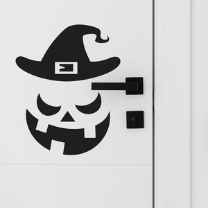Halloween pumpkin face wall decal with witch hat on white door with black handle