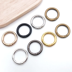 Detail of round spring snap hooks in various metallic finishes for handbag repair