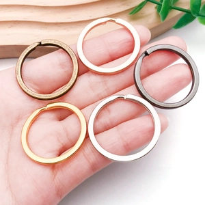 Hand holding 5 colors of flat metal key rings for DIY crafts and keychain accessories
