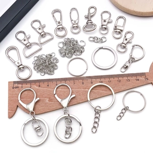 Silver metal keychain parts set including lobster clasps and rings on white background