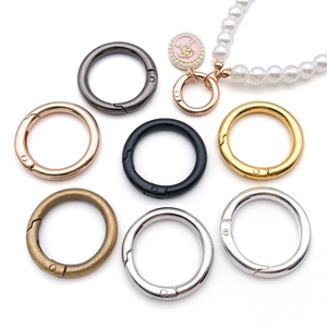 Macro detail of various metallic color alloy spring O-rings for bag strap accessories