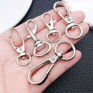 Close-up of alloy spring snap hooks and lobster clasps for DIY keychain and bag repair