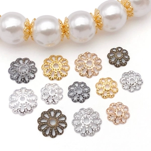Detailed view of hollow petal flower bead caps in various metallic finishes for DIY jewelry