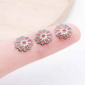 Close-up of 7mm silver hollow flower bead caps for DIY jewelry making and beading