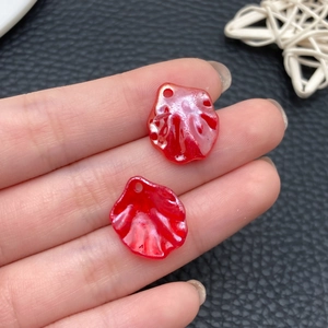 Macro shot of red acrylic flower petal pendants with pearlescent finish for DIY jewelry