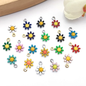 Macro detail of colorful stainless steel daisy pendants for DIY jewelry making