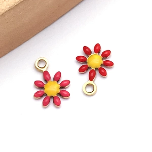 Detail of red and yellow daisy charms for jewelry making with top hanging holes