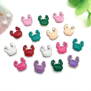 Macro detail of colorful enamel crab charms for DIY jewelry making in multiple vibrant colors