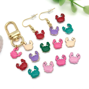 Macro detail of colorful enamel crab pendants for DIY necklaces and earrings jewelry