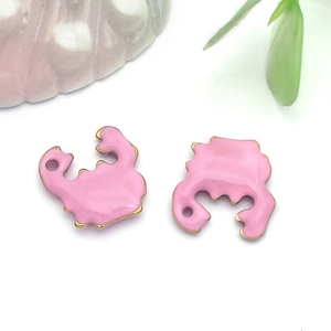 Macro shot of pink enamel gold-plated crab pendants for DIY jewelry making