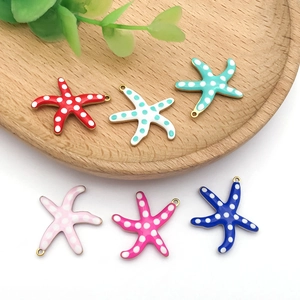 Detailed view of starfish enamel charms with polka dots for DIY jewelry making