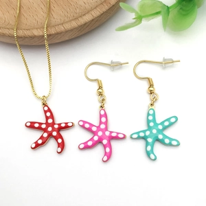 Detail of colorful starfish pendant necklace and earrings with polka dot enamel finish