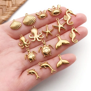 Golden stainless steel ocean pendants collection including mermaid tail, turtle and starfish