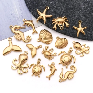 Gold plated stainless steel ocean themed charms including starfish and sea turtle pendants