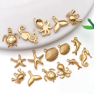 Detail of diverse gold sea animal charms including sea turtles and starfish for DIY jewelry