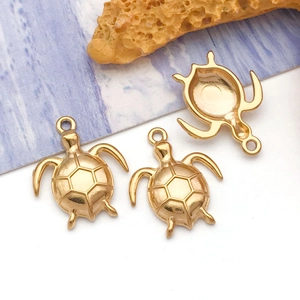 Macro detail of three golden turtle charms with hexagonal shell textures for DIY jewelry