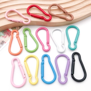 Close-up of colorful gourd-shaped aluminum carabiners in thirteen vibrant spring clip colors