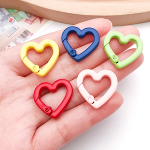 Macro detail of colorful heart-shaped alloy spring clasps for DIY bag accessories