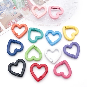 Flat lay of colorful heart-shaped alloy spring clasps in 12 vivid colors for DIY jewelry