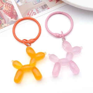 Colorful resin balloon dog keychains in pink and orange with matching metal spring rings