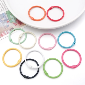 Close-up of colorful 30mm metal binder rings in various vibrant painted finishes