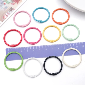 Detailed macro view of 30mm colorful metal binder rings in various vibrant painted finishes