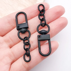Matte black zinc alloy lobster clasp with a 4-link chain held by hand for scale