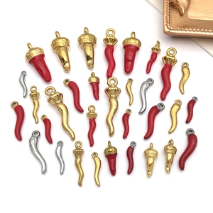 Detailed collection of red enamel and gold Italian Cornicello chili pendants for DIY jewelry