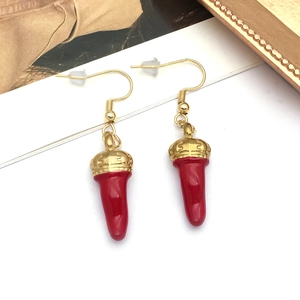 Detailed close-up of red chili pepper pendant earrings with gold caps on a white background