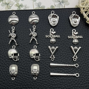 Macro view of antique silver baseball and softball themed DIY jewelry pendant charms
