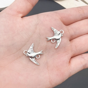 Macro shot of vintage silver bird pendants for DIY jewelry making and necklaces